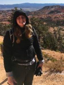 Image of Christine Olson standing outside with mountains and trees in the background